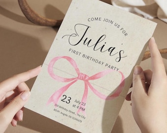 May include: A pink and white birthday invitation with a pink ribbon bow and the text "Come join us for Julia's First Birthday Party" and "23 July 23 at 4 PM".