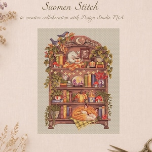 May include: A cross-stitch pattern titled Suomen Stitch in creative collaboration with Design Studio MiA, featuring a wooden bookshelf filled with books, plants, a ghost drinking from a mug, a pumpkin, and a sleeping fox on a checkered cloth.