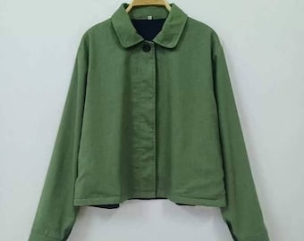 May include: A green collared jacket with a button fastening. The jacket has long sleeves and a slightly cropped hem.