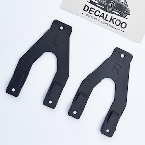 May include: Two black plastic brackets with a U-shaped opening. The brackets are labelled "L" and "R" for left and right.