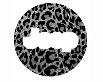 May include: A round sticker with a black and silver leopard print design. The sticker has a white space in the center.