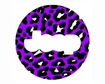 May include: Purple and black leopard print circle with a white cutout in the shape of the word "boo".