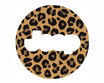 May include: A round sticker with a leopard print pattern. The sticker has a white cutout in the shape of the word "JOOJ".