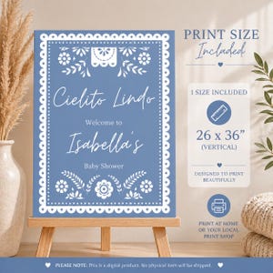 May include: A blue baby shower sign with the text "Cielito Lindo" and "Welcome to Isabella's". The sign is 26 x 36 inches and includes decorative floral elements. The sign is displayed on a wooden easel.
