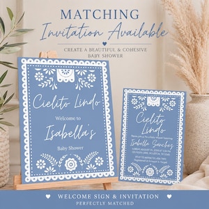 May include: A blue baby shower welcome sign and invitation with white floral and decorative border. The sign reads "Cielito Lindo" and welcomes Isabella to her baby shower. The invitation includes event details.