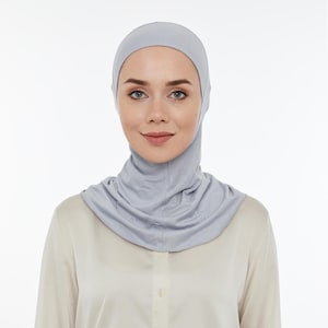 May include: A light gray jersey knit hijab with a close-fitting design that covers the head and neck.