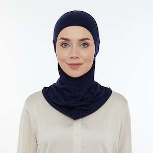 May include: A navy blue jersey knit hijab with a close-fitting style that covers the head and neck.