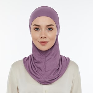 May include: A purple jersey knit hijab with a long neck and a close-fitting style.