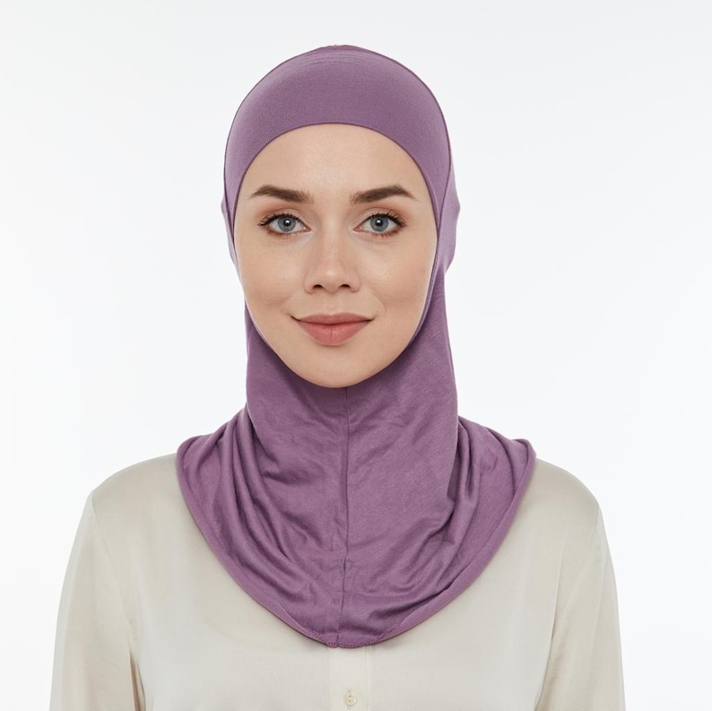 May include: A purple jersey knit hijab with a long neck and a close-fitting style.