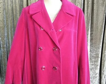 May include: A vibrant fuchsia double-breasted coat with a classic lapel collar. The coat features six silver-toned buttons and a tailored silhouette. The coat is displayed on a mannequin.