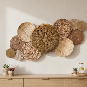 May include: A selection of woven, circular wall decorations in different sizes and textures. The pieces are mainly in natural shades of beige and brown, offering a rustic, organic look. The arrangement is displayed on a white wall.
