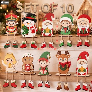 Può includere: Un set di 10 decorazioni natalizie in legno da scaffale, tra cui schiaccianoci, pupazzo di neve, gnomo, elfo, Babbo Natale, angelo, omino di pan di zenzero e renna. Ogni figura ha gambe penzolanti con stivali, alta 12,7 cm e larga 10,2-12,7 cm.