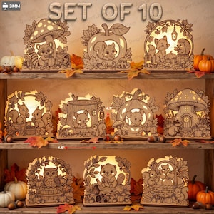 Könnte beinhalten: Ein Set aus 10 beleuchteten, lasergeschnittenen Holzaufstellern mit Waldtieren wie Waschbären, Eichhörnchen, Füchsen, Mäusen und Eulen in herbstlichen Szenen. Jedes Teil ist 11,43 cm breit und 11,94 cm hoch, bei einer Materialstärke von 3 mm.