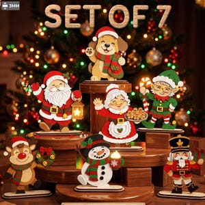 May include: A set of 7 wooden Christmas figurines featuring a dog, Santa Claus, Mrs. Claus, an elf, a reindeer, a snowman, and a nutcracker. The figures are displayed on tiered wooden stands. Text at the top reads SET OF 7 and 3MM.