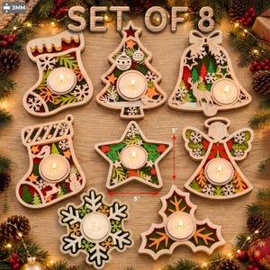 May include: A set of 8 wooden Christmas tea light candle holders in shapes including a stocking, tree, bell, star, angel, snowflake, and holly. Each piece features layered cutouts in red, green, and orange, with a 3mm thickness and 5-inch width.