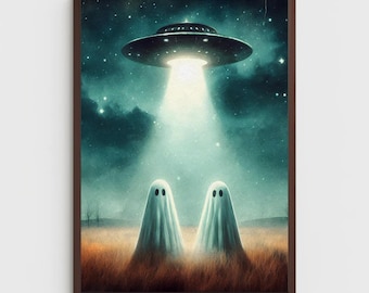 May include: A framed wall art print depicting two white ghost figures standing in a dry, golden-brown field at night. Above them, a dark metallic UFO hovers in a starry, teal-toned sky, casting a bright, focused beam of light down onto the ghosts.