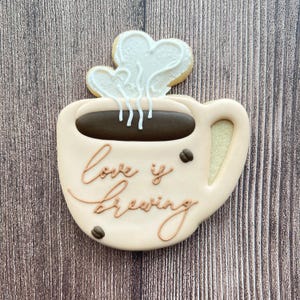 a latte mug with steam hearts sugar cookie