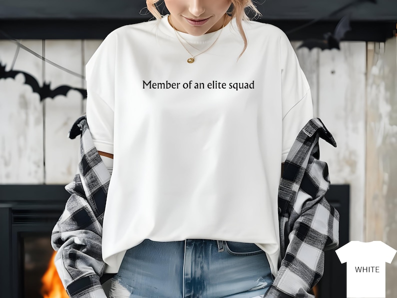 May include: White long-sleeve shirt with the text "Member of an elite squad" printed on the front.