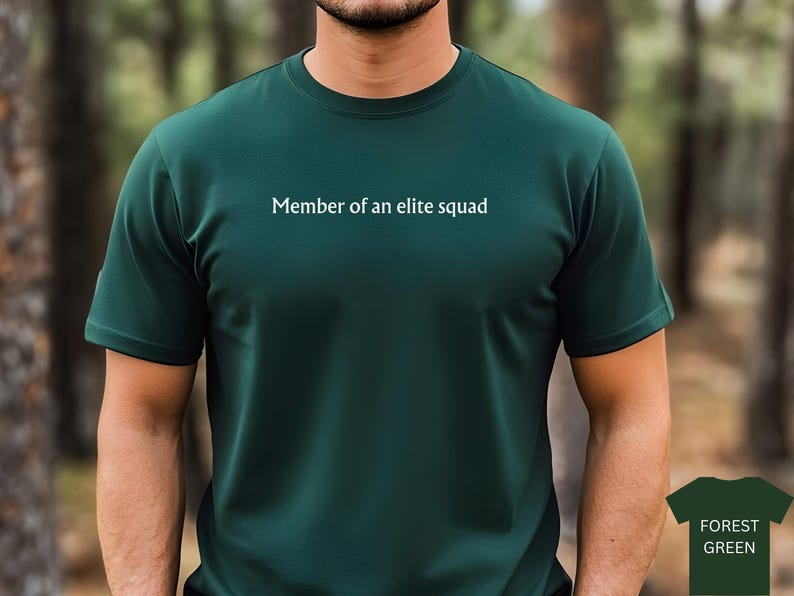 May include: A dark green t-shirt with the text "Member of an elite squad" printed on the front.