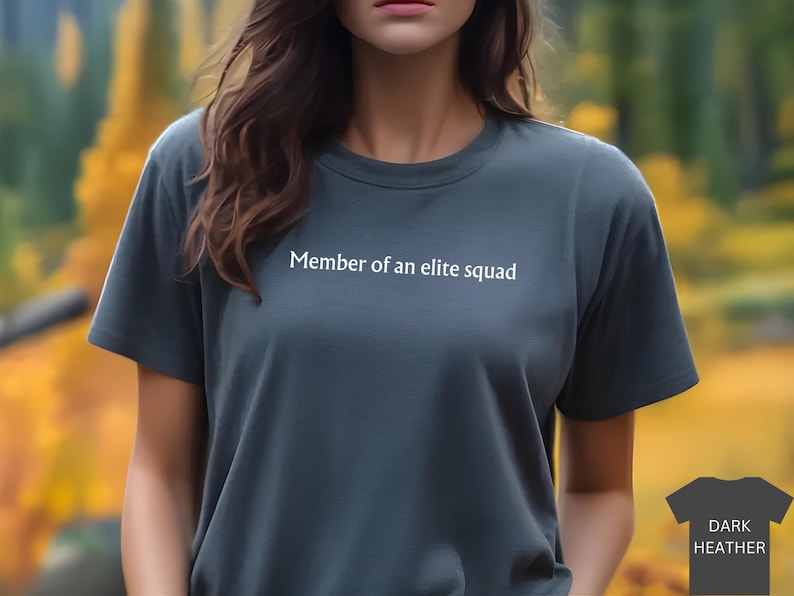 May include: A dark heather grey t-shirt with the text "Member of an elite squad" printed on the front.