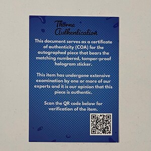 May include: A blue certificate of authenticity with the text "Thorne Authentication." The document states it serves as a COA for an autographed item with a matching hologram sticker. It also includes a QR code for verification.