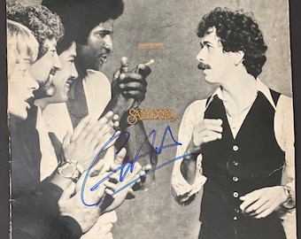 Autógrafo de Carlos Santana en funda de LP con certificado de autenticidad