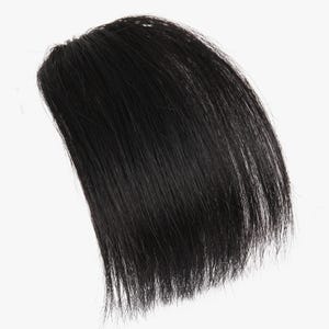 May include: A section of black hair, likely a hairpiece or wig, against a white background. The hair is straight and appears to be a solid, dark black color. The strands are neatly aligned, suggesting a manufactured product.