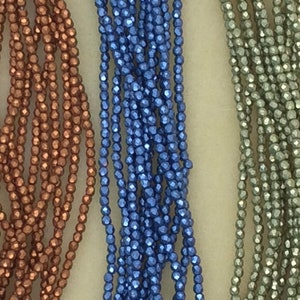 May include: Three strands of faceted glass beads, one copper, one blue, and one green.
