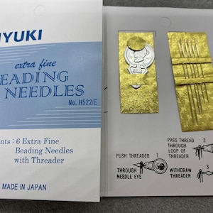 May include: A package of Miyuki extra fine beading needles with a threader. The package includes 6 needles and instructions on how to use the threader. The package is labeled "No. H522/E" and "Made in Japan".