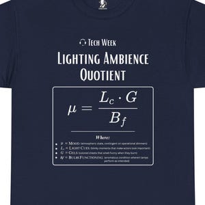 May include: Navy blue t-shirt with white text. The shirt features the text "Tech Week" and "Lighting Ambience Quotient" above a mathematical formula. Below the formula, the shirt lists what each variable represents.