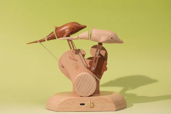 An ultra-silent mechanical dolphin automaton designed for nurseries — soothing motion art that bridges kinetic sculpture and calming decor.