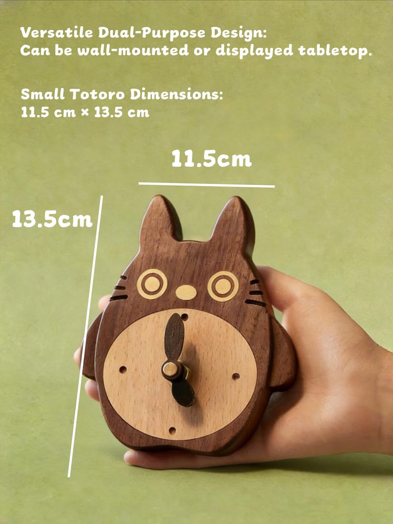 May include: A wooden Totoro-shaped clock, 11.5 cm x 13.5 cm, with a light wood face and dark wood body. The clock has a black clock hand and is designed to be wall-mounted or displayed on a tabletop. The clock has a light green background.