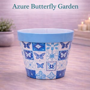 May include: A ceramic BloomShape Puzzle Pot with an Azure Butterfly Garden design. The pot features a light blue rim and a white interior. The exterior is decorated with blue butterfly and floral patterns.
