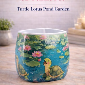 May include: A 3D puzzle pot with a Turtle Lotus Pond Garden design. The pot features a blue pond scene with turtles, lily pads, and pink lotus flowers. The text "3D Puzzle Pot" and "Turtle Lotus Pond Garden" are visible.