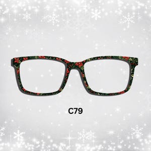 May include: Black framed eyeglasses with a red and green floral pattern. The glasses are on a white background with a snowflake pattern. The text "C79" is below the glasses.