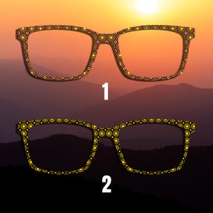 May include: Two pairs of eyeglasses with decorative yellow and black patterned frames. The frames are outlined with a repeating geometric design. The background features a sunset over a mountain range, with the numbers "1" and "2" in white.