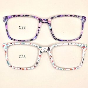 May include: Two pairs of eyeglasses with colorful Christmas-themed patterns on the frames. The top pair has a purple and pink pattern and the text "C33". The bottom pair has a white and red pattern and the text "C28".
