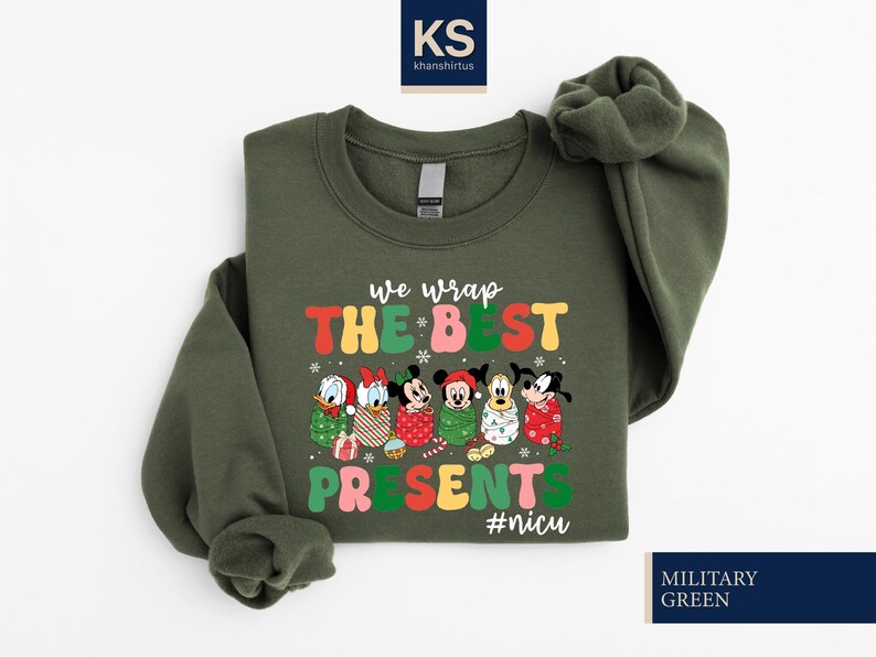 A green sweatshirt with a colorful graphic design featuring Disney characters and the text "We wrap the best presents #niscu" printed on it.