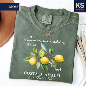 a green t - shirt with a picture of lemons on it