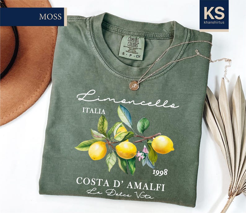 a green t - shirt with a picture of lemons on it