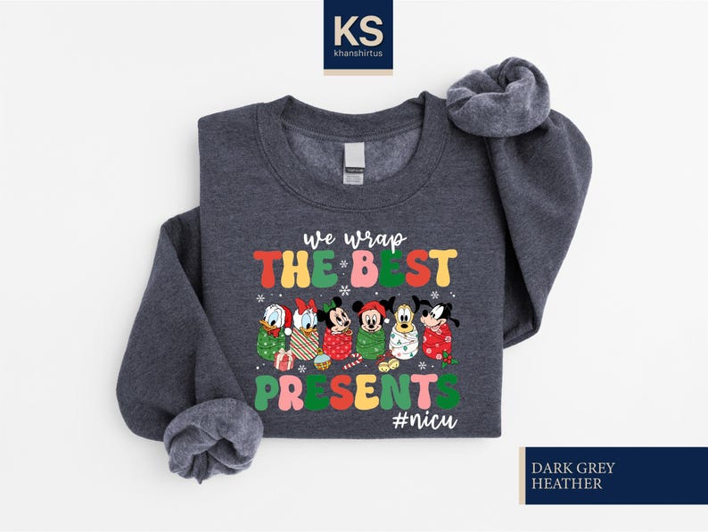 A gray sweatshirt with a colorful graphic design featuring characters from Disney and the text "We wrap the best presents #niscu" printed on it.