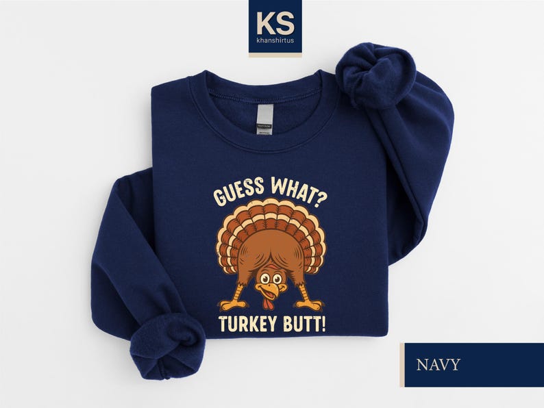A navy blue sweatshirt with a graphic of a turkey and the text "Guess What? Turkey Butt!" printed on it.