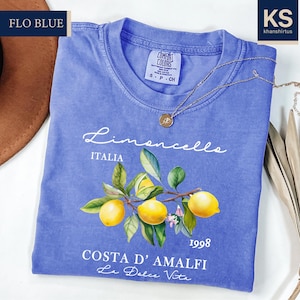 a blue t - shirt with a picture of lemons on it