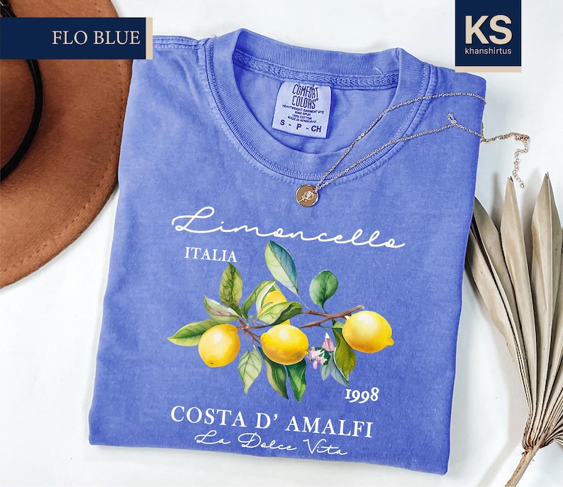 a blue t - shirt with a picture of lemons on it