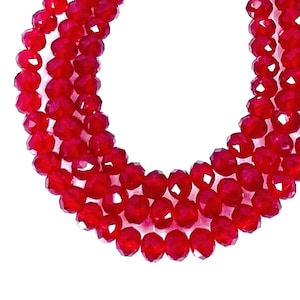 May include: A strand of red crystal beads, with a faceted finish, strung on a clear thread.