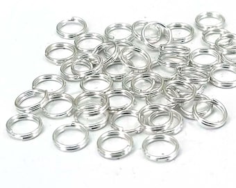 May include: A large pile of silver jump rings. The rings are small and round, and they are perfect for jewelry making.