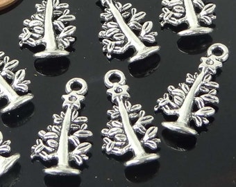 May include: Ten silver-toned Christmas tree charms with a star on top. The charms are about the size of a US penny.