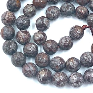 May include: A strand of gray and brown gemstone beads with a textured surface. The beads are round and have a speckled pattern. The strand is approximately 18 inches long.