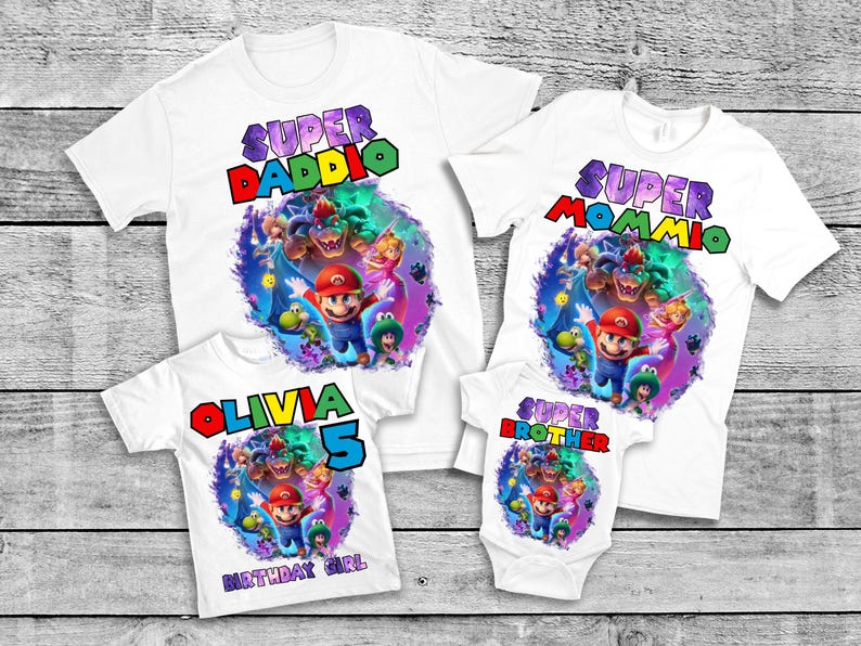 May include: White t-shirts with colorful graphics featuring characters from a video game. The shirts have text that reads "Super Daddio", "Super Mommio", "Olivia 5 Birthday Girl", and "Super Brother".