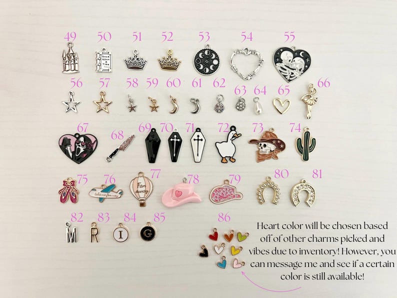 May include: A collection of metal charms in various shapes, including stars, crowns, hearts, and a cactus. The charms are in silver, gold, black, and other colors. Text on the image says "Heart color will be chosen based off of other charms picked and vibes due to inventory!"